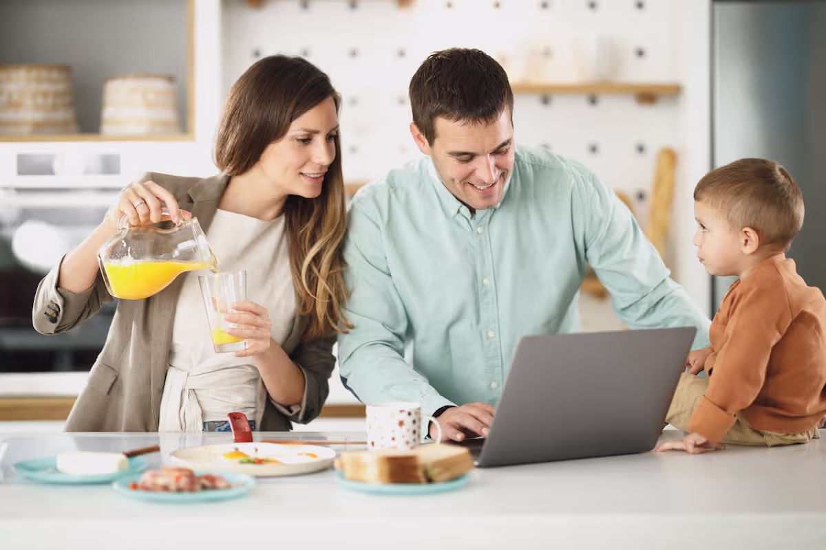 Smiling Canadian family reviewing their finances together